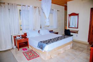 Ένα ή περισσότερα κρεβάτια σε δωμάτιο στο Kigali Diplomat Hotel +81 φωτογραφίες