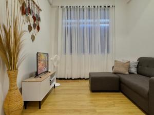 a living room with a couch and a vase at LT Home 2 in Sandakan