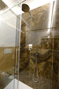 a bathroom with a shower with a glass door at Perla Blu by PortofinoVacanze in Rapallo +14 photos