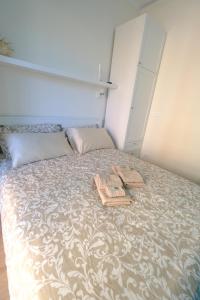 a bedroom with a bed with two towels on it at Perla Blu by PortofinoVacanze in Rapallo