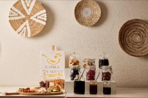a table with some food and jars of jam at Nissi Park Hotel in Ayia Napa