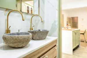 two sinks sitting on a counter in a bathroom at A casa da Ermida de Aljustrel in Aljustrel