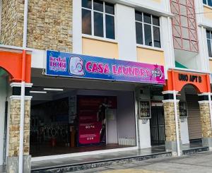 a store with a sign on the front of a building at LT Home 2 in Sandakan
