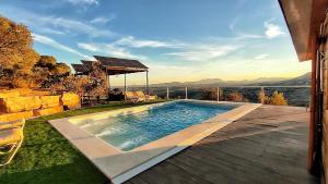 a swimming pool with a view of the mountains at Cabaña 99 by Villamya in El Gastor
