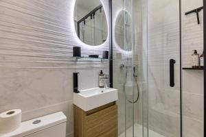 une salle de bains avec douche, lavabo et miroir dans l'établissement Petit Vicomte joli studio place du Vieux Marché, à Rouen