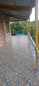 a walkway with a tiled floor and a building at The ORION Homestay in Mukteswar +36 photos