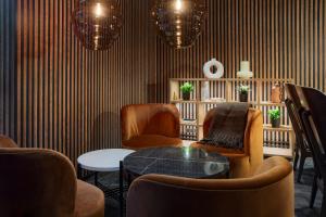 a living room with two chairs and a table at Original Sokos Hotel Vantaa in Vantaa