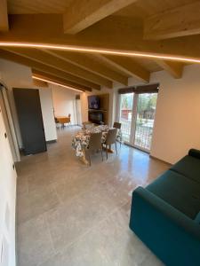 a large living room with a table and chairs at CA del BRENZ in Folgarida