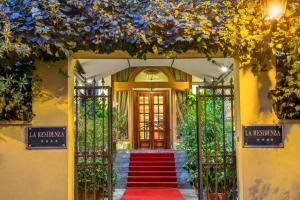 an entrance to a house with a red carpet at La Residenza in Rome