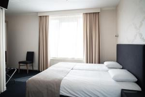 Postel nebo postele na pokoji v ubytování Hotel Essenza