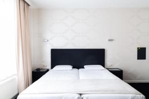 Postel nebo postele na pokoji v ubytování Hotel Essenza