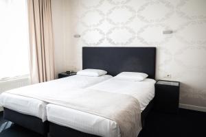 Postel nebo postele na pokoji v ubytování Hotel Essenza