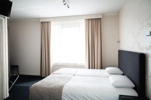 Postel nebo postele na pokoji v ubytování Hotel Essenza