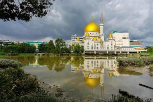 a building with a gold dome on top of a body of water at Sea Lion Hotel @ Klang in Klang