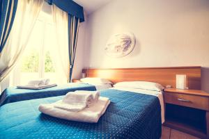 Postel nebo postele na pokoji v ubytování Hotel La Gaietta