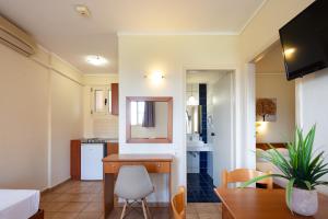 a kitchen and living room with a table and a mirror at Dia Apartments in Hersonissos