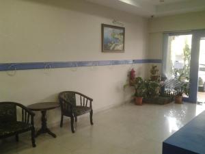 a room with two chairs and a table and a table at Sea Front Hotel Port Dickson in Kampong Arab