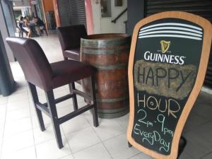 a chair and a sign with a sign for a restaurant at Zotel Business & Leisure Hotel in Kampong Tabuan