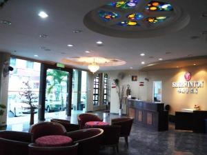 a restaurant with a bar and chairs and a ceiling at Sherrinton Hotel in Mentekab