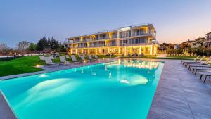 a hotel with a swimming pool in front of a building at Vision Hotel in Peschiera del Garda +27 photos