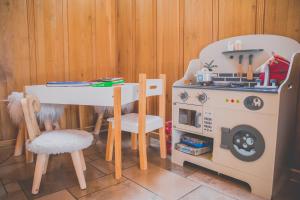 a toy kitchen with a table and a stove at Willa Chruślice-Basen sezon,Sauna in Nowy Sącz
