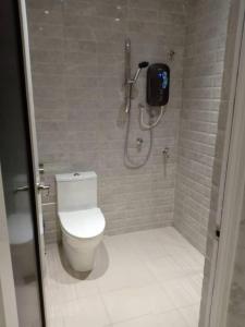 a bathroom with a toilet and a shower stall at Twin Star Hotel in Tanjung Malim +49 photos