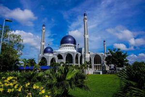 a white building with blue domes on top of it at OYO 718 Mr J Hotel Wakaf Che Yeh 1 in Kota Bharu