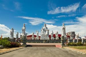 a bunch of statues in front of a building at OYO 1111 Harmony Stay in Miri