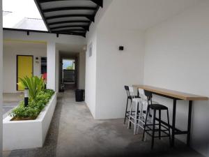 a dining room with a table and stools at Kinta Valley Retreat in Ipoh