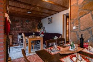 a room with a table and chairs and a living room at Villa Ela in Kupres +29 photos