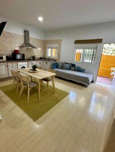 a kitchen and living room with a table and a couch at Casa a 65 metros de la Playa in El Palmar