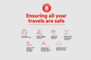 a sign that reads ensuring all your travels are safe with illustrations of people at OYO 89643 S.s Motel in Pantai Cenang