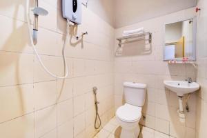 a bathroom with a shower and a toilet and a sink at OYO 89643 S.s Motel in Pantai Cenang +34 photos