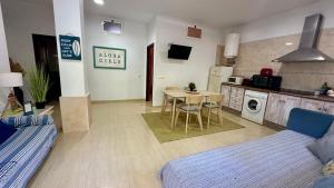 a living room with a kitchen and a table and chairs at Casa a 65 metros de la Playa in El Palmar +12 photos