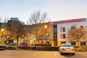 a large building with a sign on the side of it at Ramada London North in Barnet