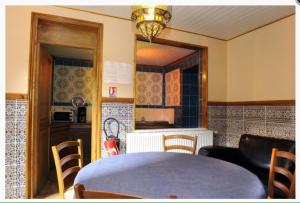 a kitchen with a table and chairs and a kitchen with a kitchen at Chambre D'hôtes Anzi in Arcis-sur-Aube