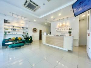 a lobby with a waiting room with a table and chairs at ATAP Hotel in Kota Kinabalu