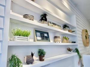a room with white shelves with potted plants at ATAP Hotel in Kota Kinabalu