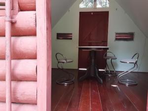 a room with a table and chairs in a room at SPOT ON 90536 Bens Maju Foreststay in Melaka