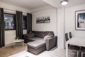 a living room with a couch and a table at Citynest in Rovaniemi