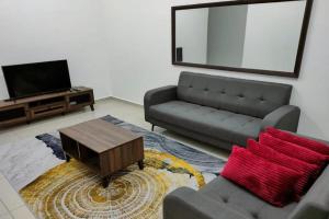 a living room with a couch and a tv at OYO Homes 90611 Homestay D'emas in Melaka