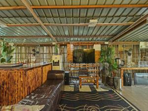a living room with a couch and a television at OYO 90636 Teratak Zakiah Chalet in Jerantut