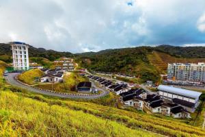 a small town on a hill with a road and buildings at The Hotel Tudor Inn in Cameron Highlands