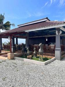 a statue of three sheepitures in front of a building at OYO 90818 Cemara Puri Resort & Spa in Kampong Pantai Batu Hitam