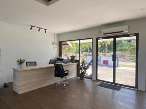 an office with a desk with a computer and a chair at OYO 90818 Cemara Puri Resort & Spa in Kampong Pantai Batu Hitam
