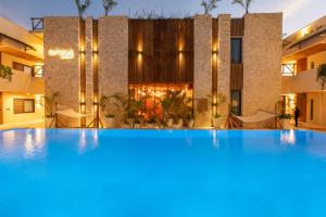 a large swimming pool in front of a building at Samawa Living in Paje