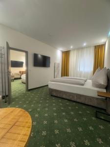 a bedroom with a large bed and a television at City Apartments - Nürnberg Altstadt in Nürnberg