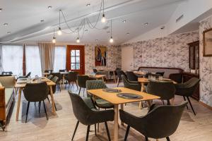 a restaurant with tables and chairs in a room at Fonnental Design Hotel Tallinn in Tallinn