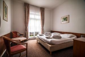 Voodi või voodid majutusasutuse Hotel Skála toas