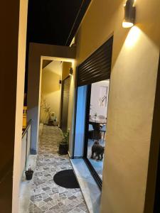a dog is sitting in the hallway of a house at Attrayant et unique in Mahdia